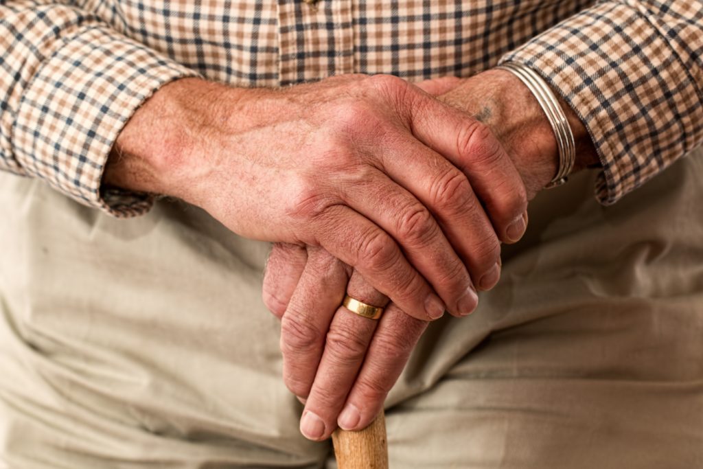 Senior man resting hands
